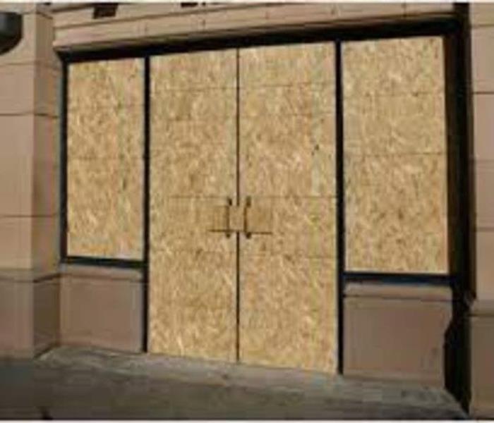 front of commercial building that is boarded up