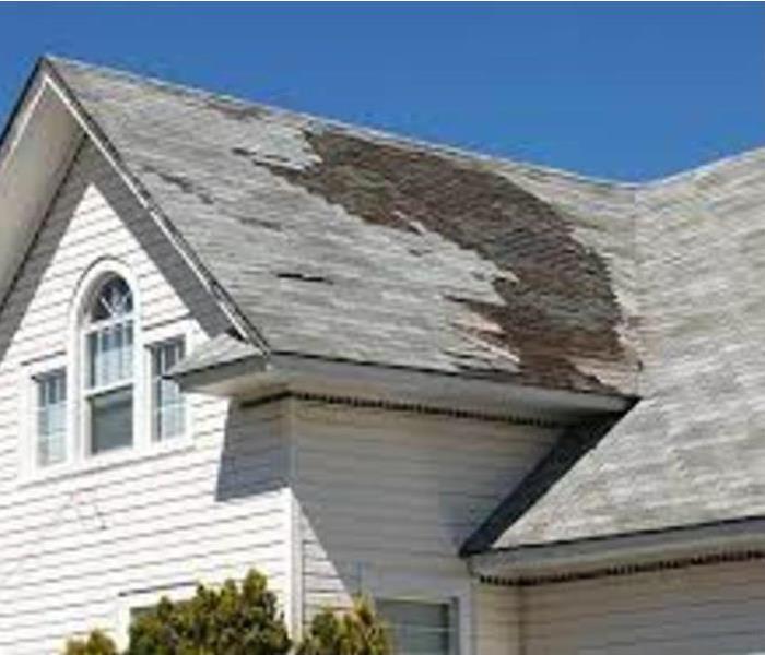 storm damage on a roof of a house