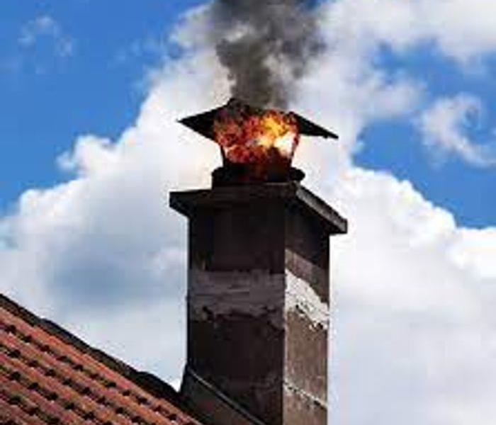 Fire coming out the top of a chimney